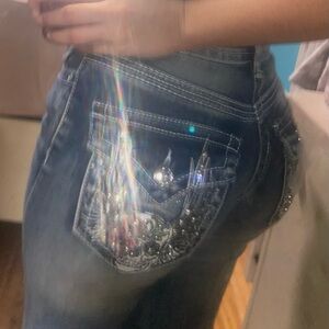 Embroidered skull and rose pocket blue jeans